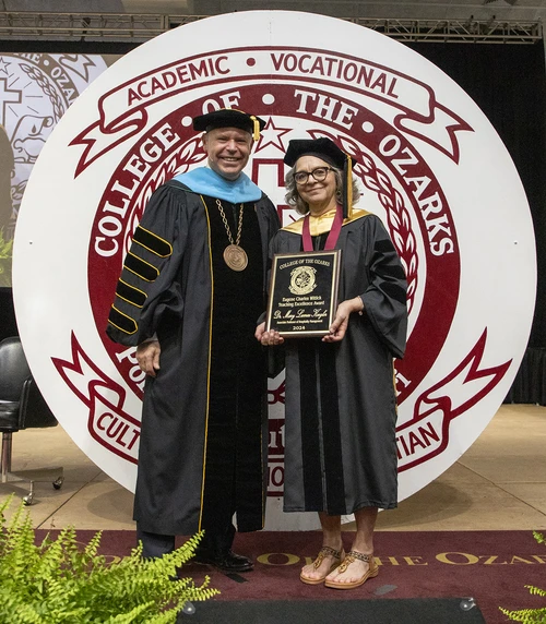 Two people with an award 